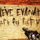 The message "We've Evacuated! Left For Fort Hope!" spray painted on a wall.